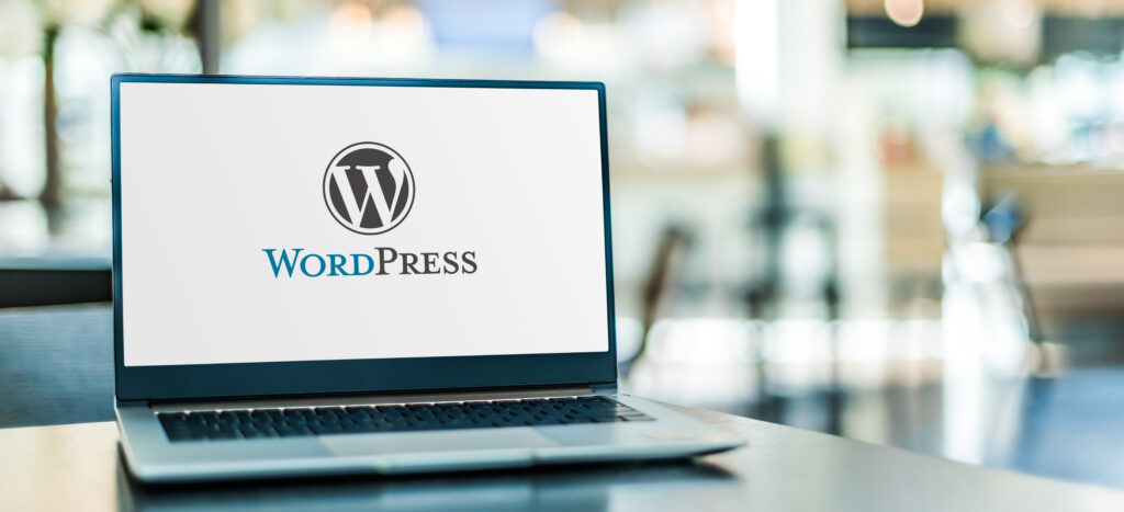 A laptop displaying the WordPress logo, symbolizing the creation of user-friendly websites designed for seamless functionality and intuitive navigation.