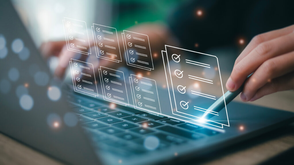 Close-up of a person using a stylus on a laptop with floating digital checklists, symbolizing trust signals and website credibility features.